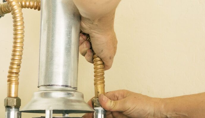 adult-male-hands-on-water-line-going-into-a-hot-wa-2025-01-10-15-20-28-utc