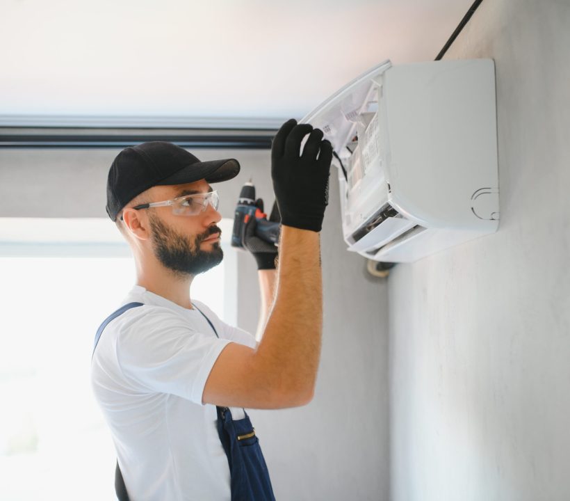 Repairman fix air conditioning systems, Male technicians service for repair and maintenance of air conditioners, Air conditioning technicians install new air conditioners in homes.