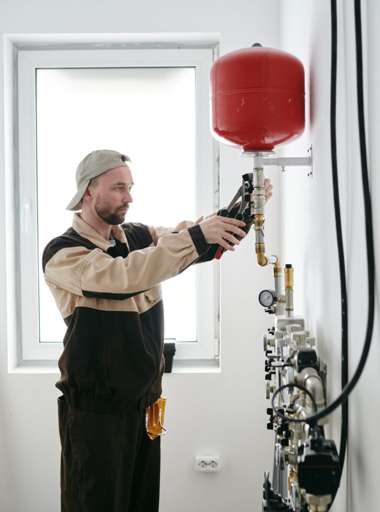 Modern plumber fixing new equipment in house or apartment Modern plumber fixing new toilet equipment in house or apartment