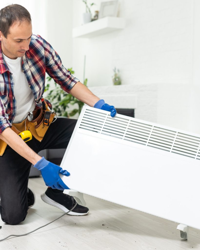 Quality help. Handyman using pipe wrench while repairing radiator battery in the room. Heating restoration Quality help. Handyman using pipe wrench while repairing radiator battery in the room. Heating restoration. High quality photo