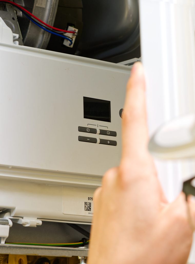 Maintenance and Repair of a gas boiler, setting up and servicing. Technician servicing the gas boiler for hot water and heating. heating servicing concept
